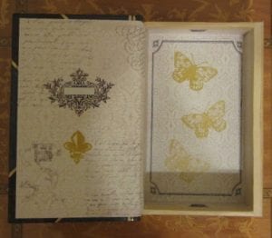 Metallic gold hand-stamped butterflies embellish the inside of most boxes