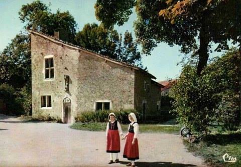 Girls in Domrémy traditional dress in front of Joan's original Domrémy home