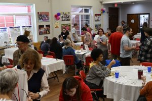 View of bustling room at New Year's Work Party